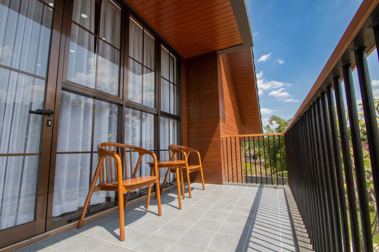 a couple of chairs sitting on top of a balcony